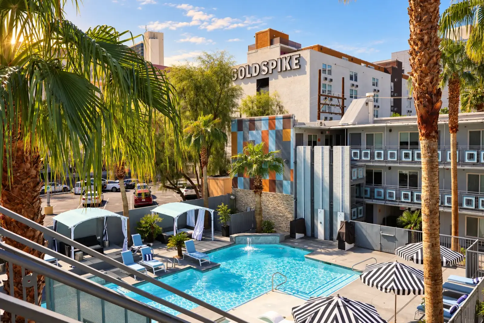 The pool from the upper walkway, palms and cabanas